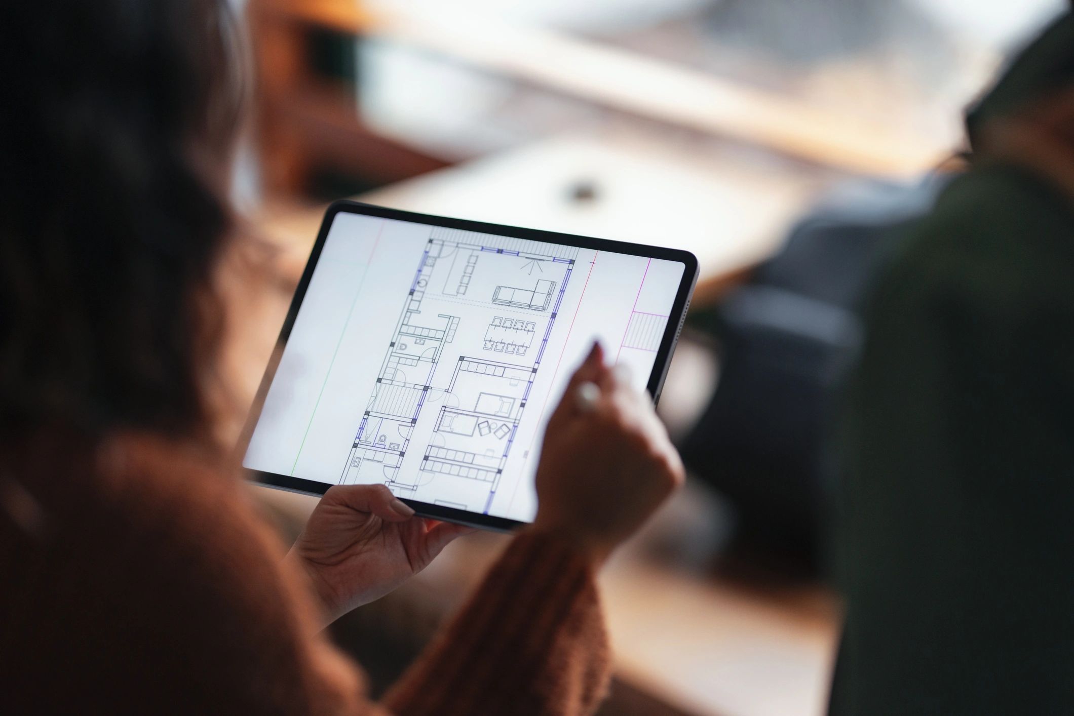 Student viewing architectural floor plan on tablet